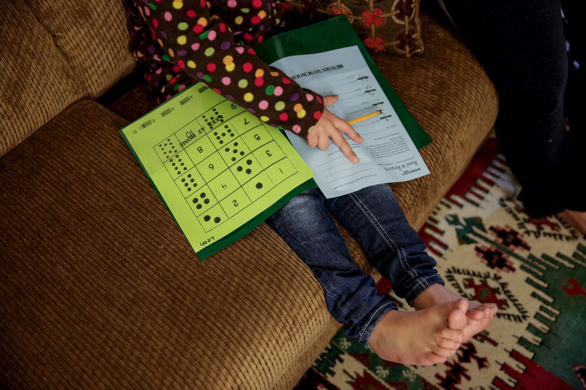 Five-year-old Syrian refugee Leen works on her homework at her new home in Sacramento, California.  Leen and her family fled violence in Syria three and a half years ago and arrived in Sacramento in September 2015 after living in Jordan. Her face is exclu