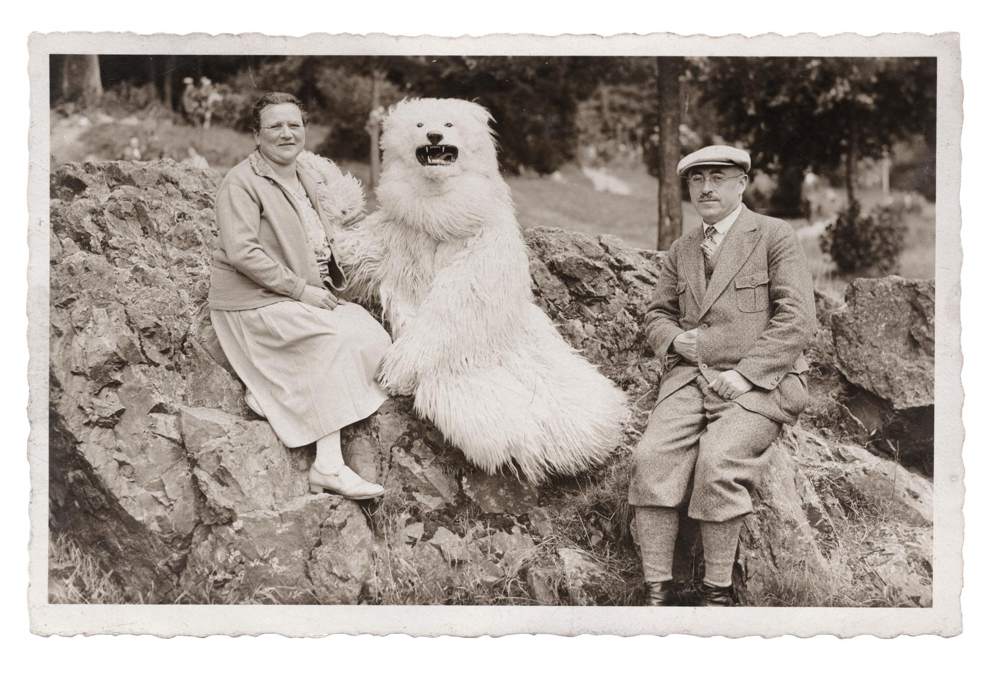 A couple pose on a rock with a "polar bear" somewhere in Germany