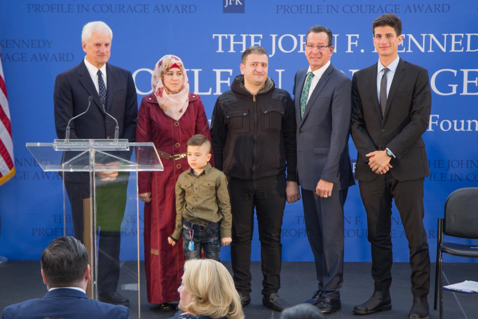 This Syrian couple and their 5 year old son lauded Gov. Dannel Malloy (second from right) for personally welcoming them to Indiana last November. The family is withholding their last name due to concerns about the safety of relatives back in Syria.