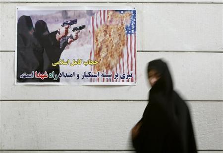 An Iranian woman walks past an anti-U.S. poster during a visit to a war museum in the city of Khorramshahr, southwest of Tehran in 2007.