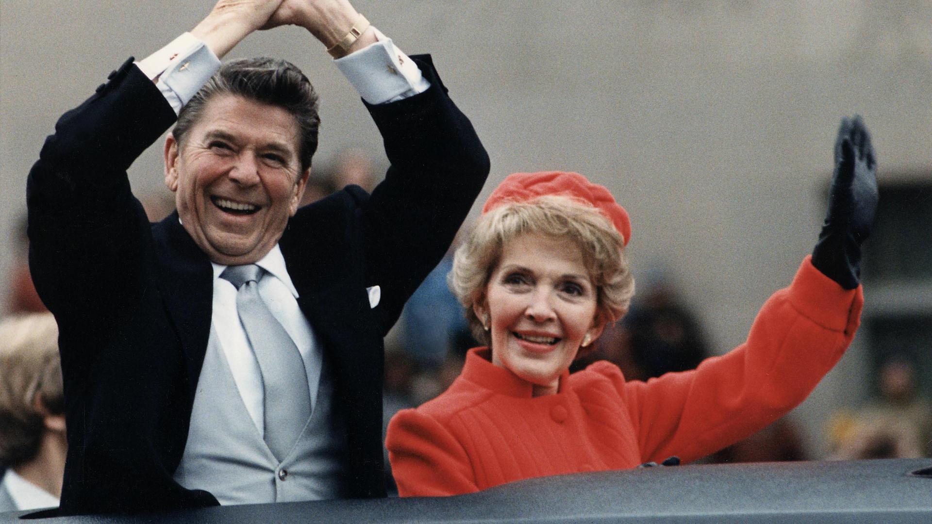 Ronald Reagan and his wife, Nancy, wave to crowds from their limousine during Reagan's first inauguration parade in 1981.