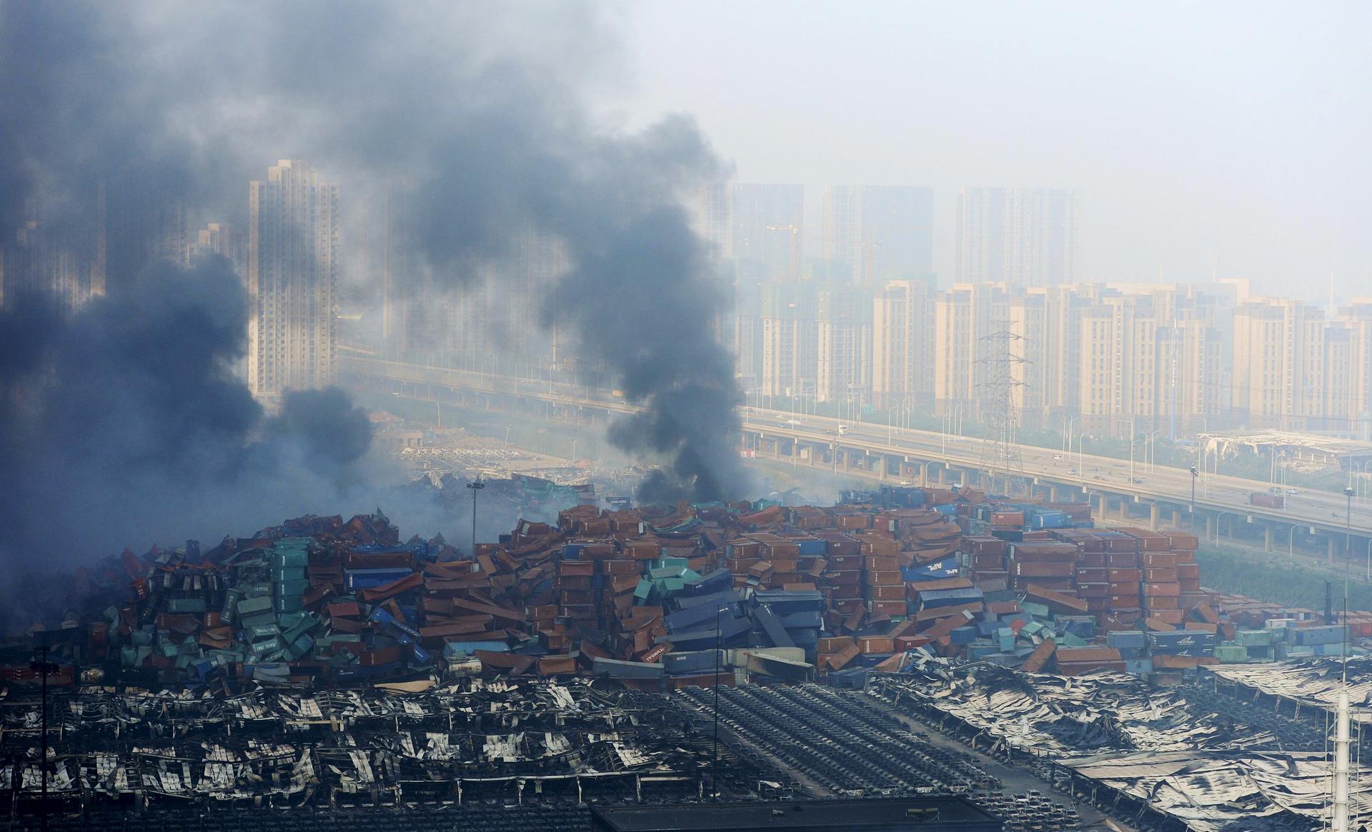 Smoke rises from shipping containers after explosions in Tianjin, China, August 13, 2015. Two massive explosions caused by flammable goods ripped through an industrial area in the northeast Chinese port city.