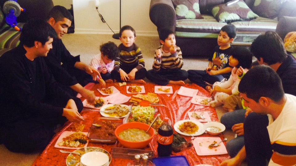 The families of former Afghan interpreters Janis Shanwari and Ajmal Faqiri gather for a holiday lunch on Thursday. 