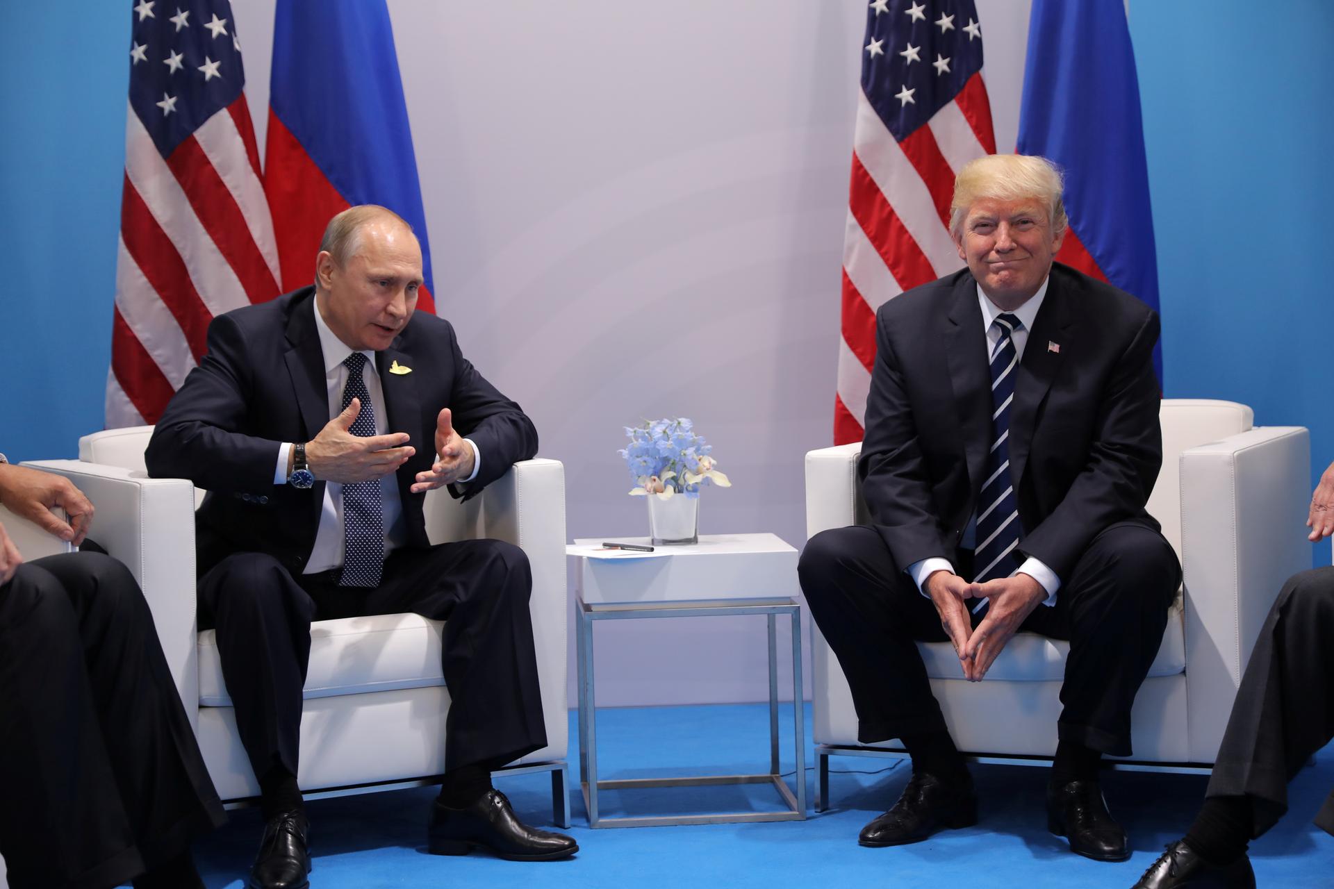 Russia's President Vladimir Putin talks to President Donald Trump during their bilateral meeting in Germany.