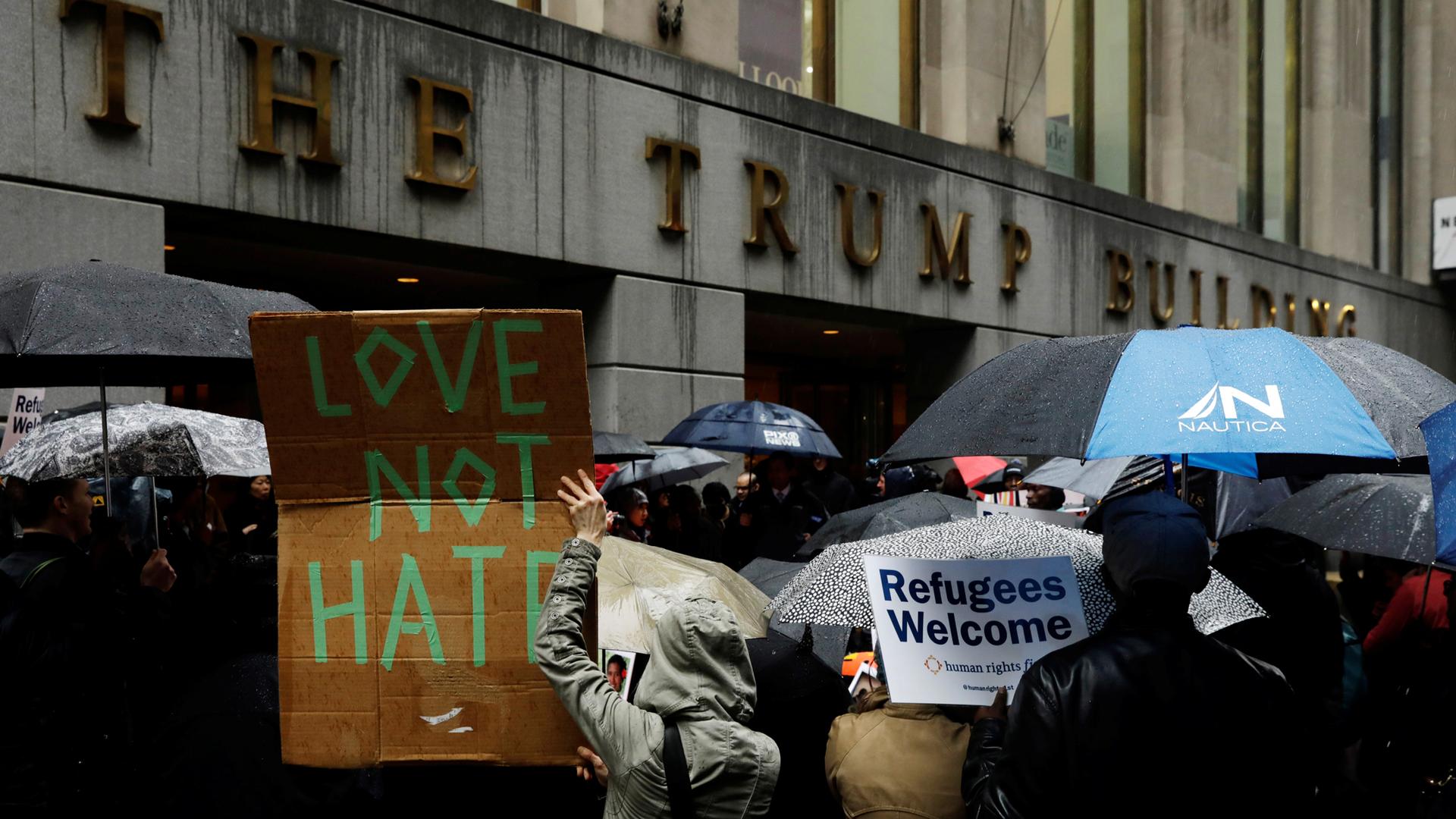 Demonstrators march outside the Trump Building in New York, March 28, 2017.