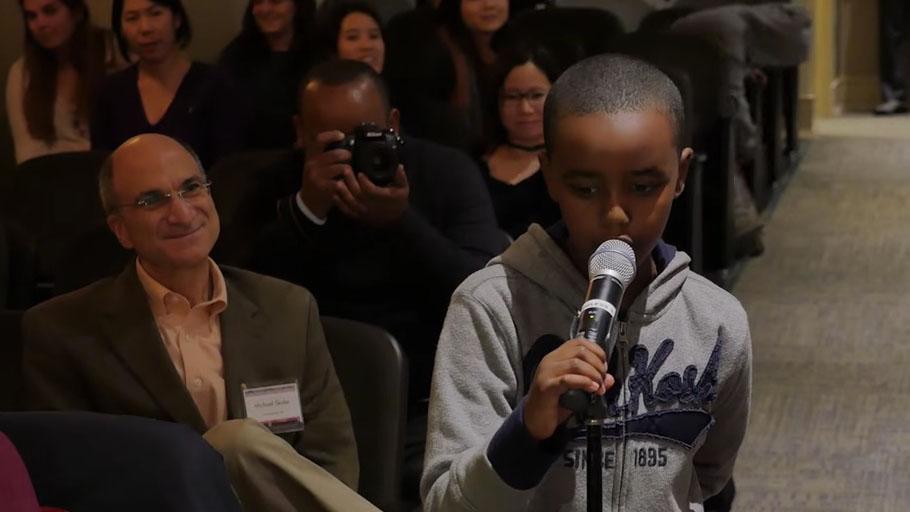 A boy asks a question during PRI's forum on the refugee crisis at Macalester College on Oct. 29.