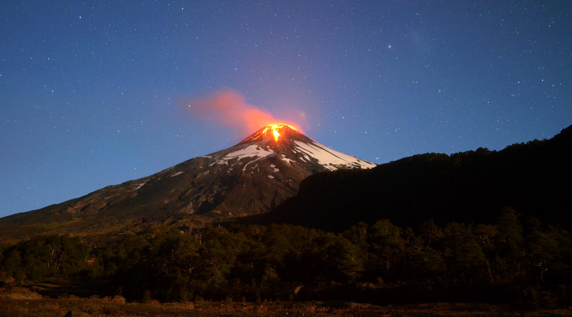Ash and lava spew from the Villarrica volcano, as seen from Pucon town in the south of Santiago.