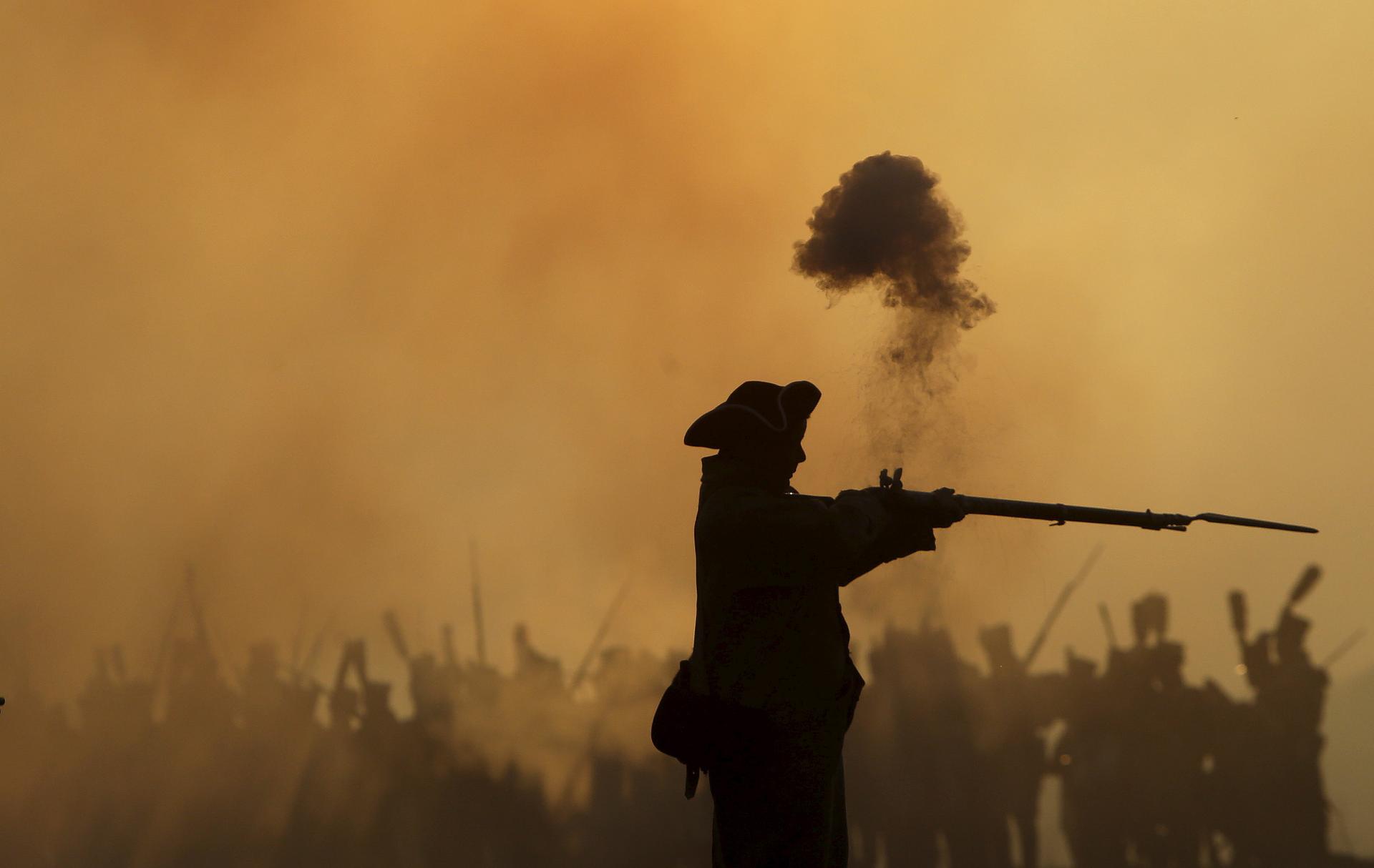 A history enthusiast, dressed as a soldier, fights during the re-enactment of Napoleon's famous battle of Austerlitz.