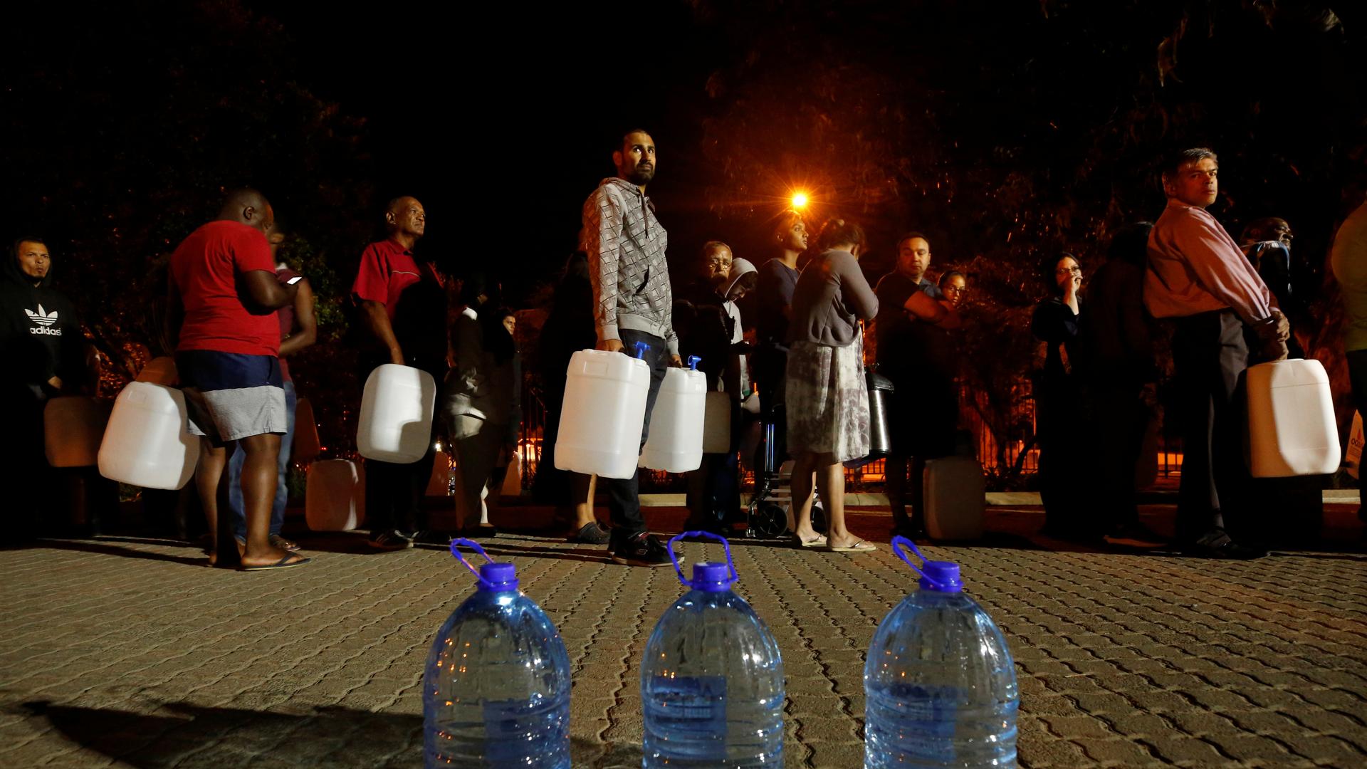 People queued to collect water as fears over the city's water crisis grew earlier this year in Cape Town, South Africa.