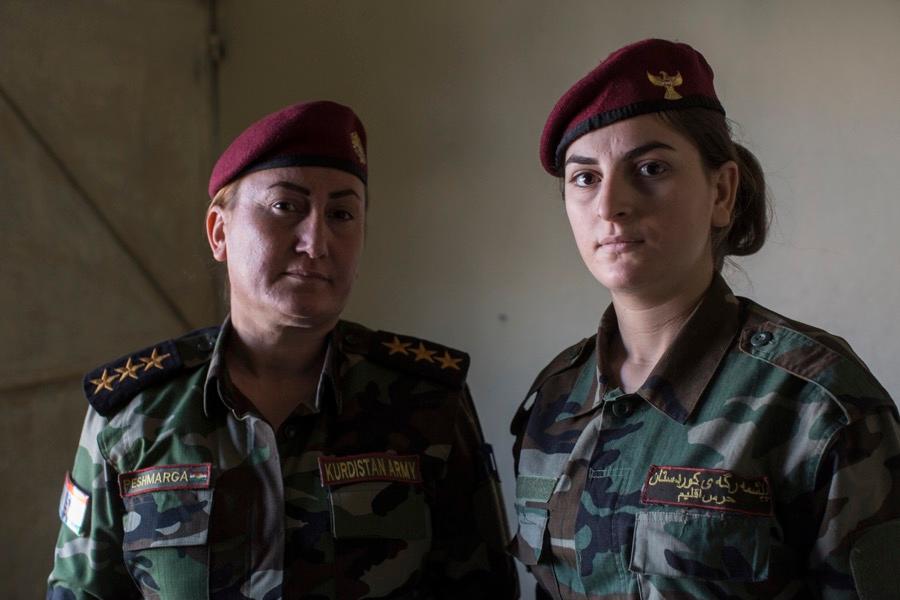 Capt. Khatoon Khider, left, commander of the all-female Yazidi Sun Brigade, with her sister, Aliya, in a home near the city of Dohuk, in Iraqi Kurdistan, on Sept. 24.