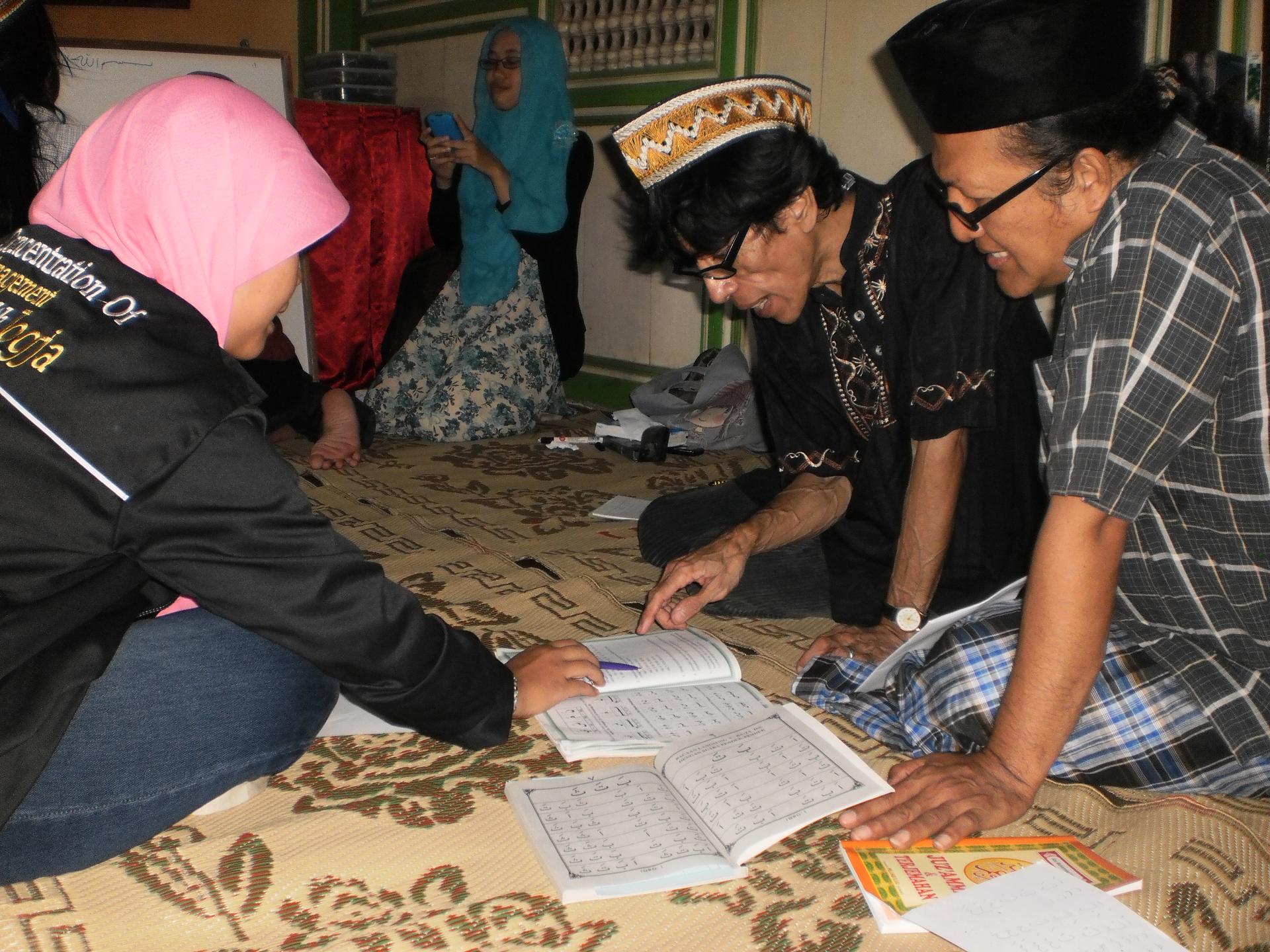 Transgender women study during an Arabic class at the Pondok Pesantren Waria Islamic school in Indonesia. Bunda Yeti, wearing a plaid shirt (at right), says the school has given her a place to practice her faith free of worry.