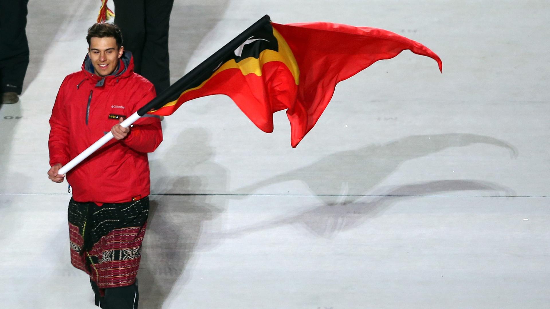 Skier Yohan Goncalves Goutt of the Timor-Leste Olympic team carries his country's flag during the Opening Ceremony of the Sochi 2014 Winter Olympics.