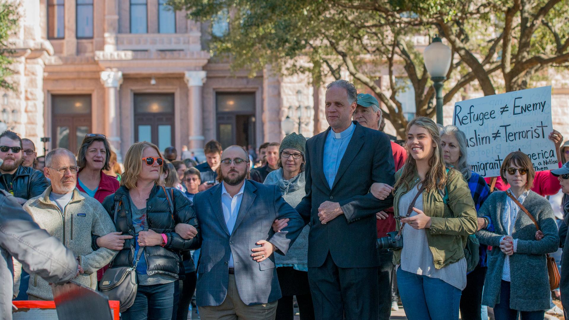 Volunteers showed up by the hundreds at "Texas Muslim Capitol Day" in Austin on Tuesday, and they locked arms to prevent anti-Muslim protesters from approaching the rally. 
