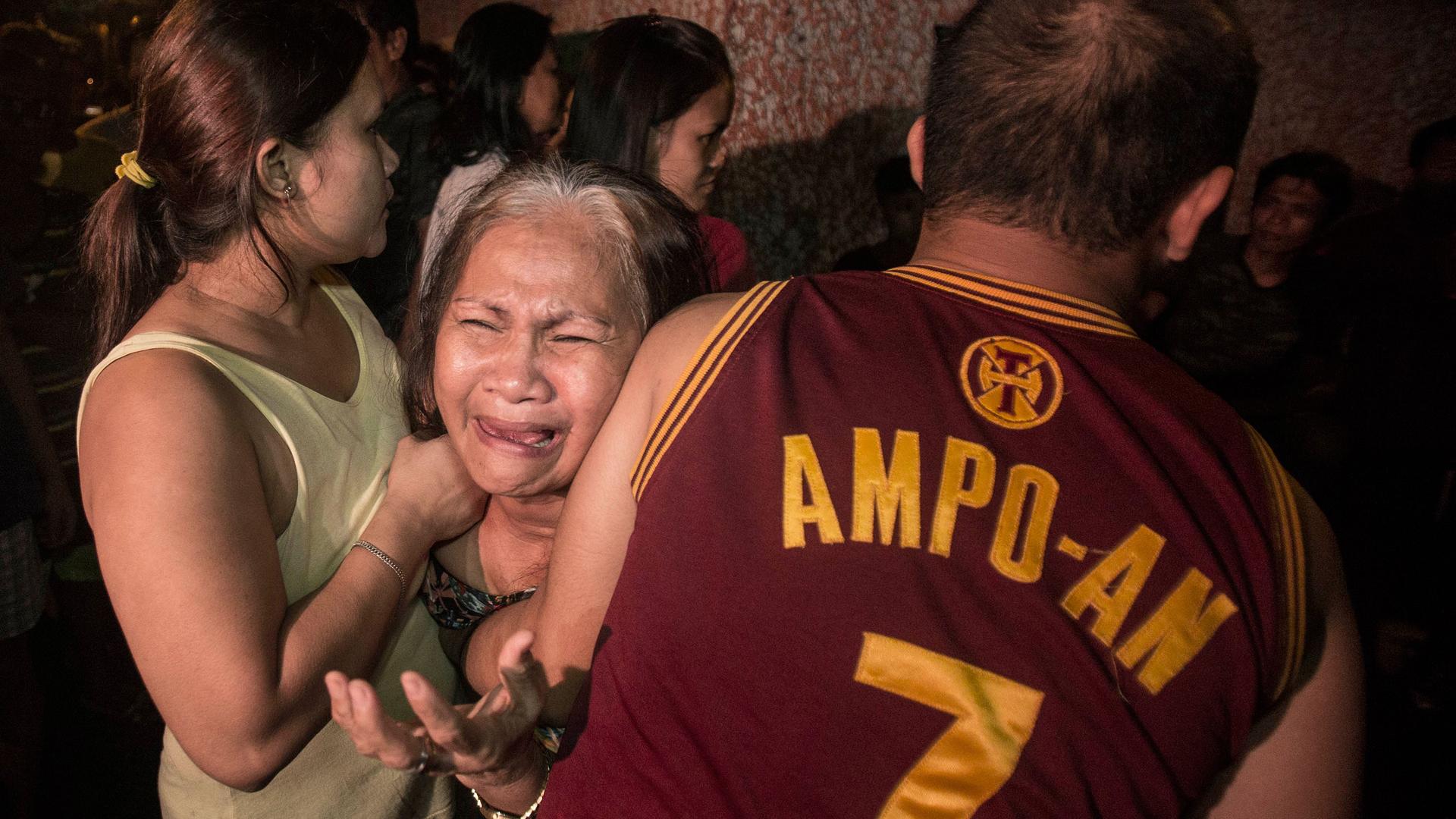 Yolanda Ampoan is hugged by her children after learning of the death of her son Sandrex Ampo. Ampo was killed by unknown assailant on September 23, 2016 in Punta Sta Ana, Manila.