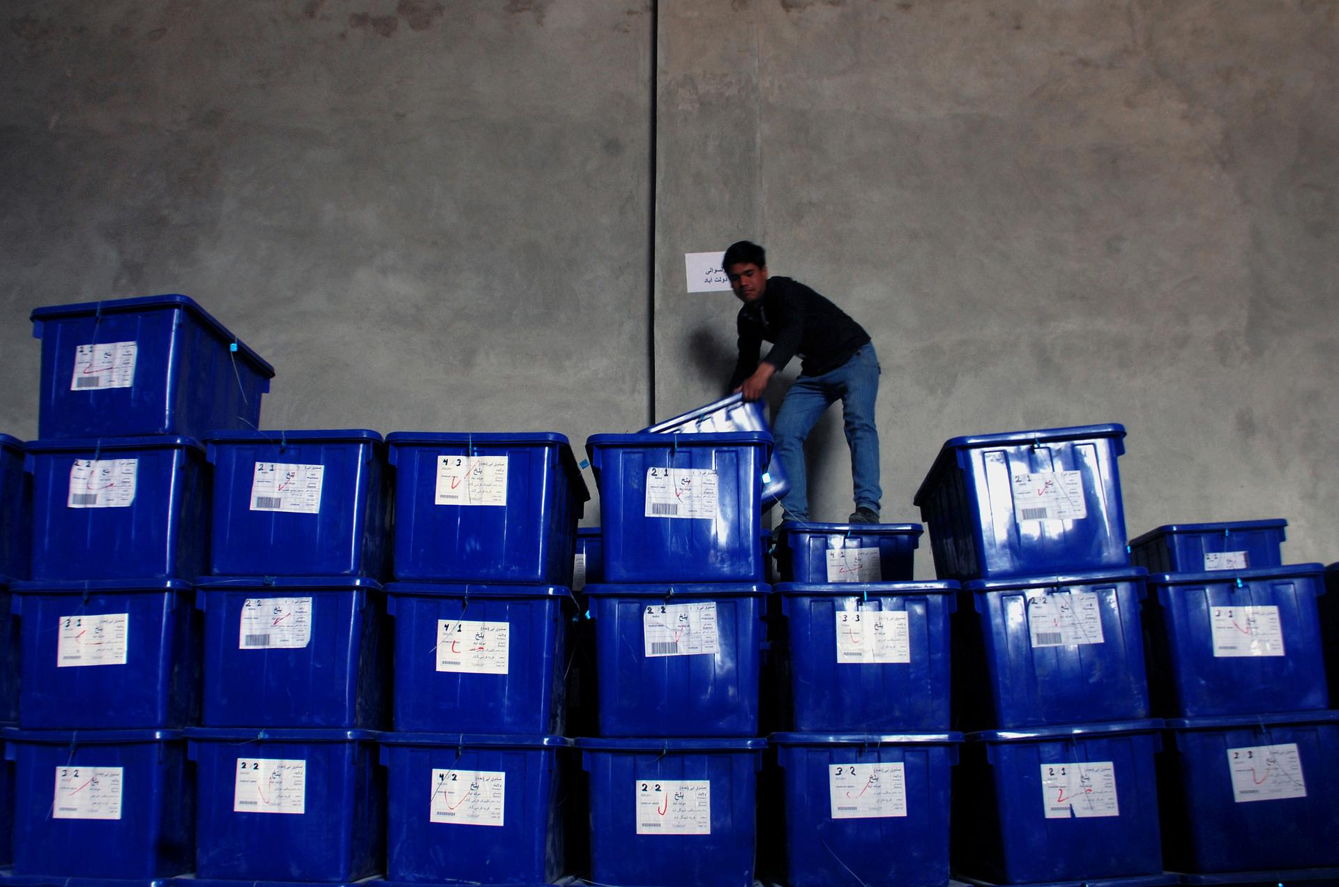 An Afghan election commission worker arranges boxes containing election material in Mazar-I-Shariff April 1, 2014.The Afghan presidential elections will be held on April 5.