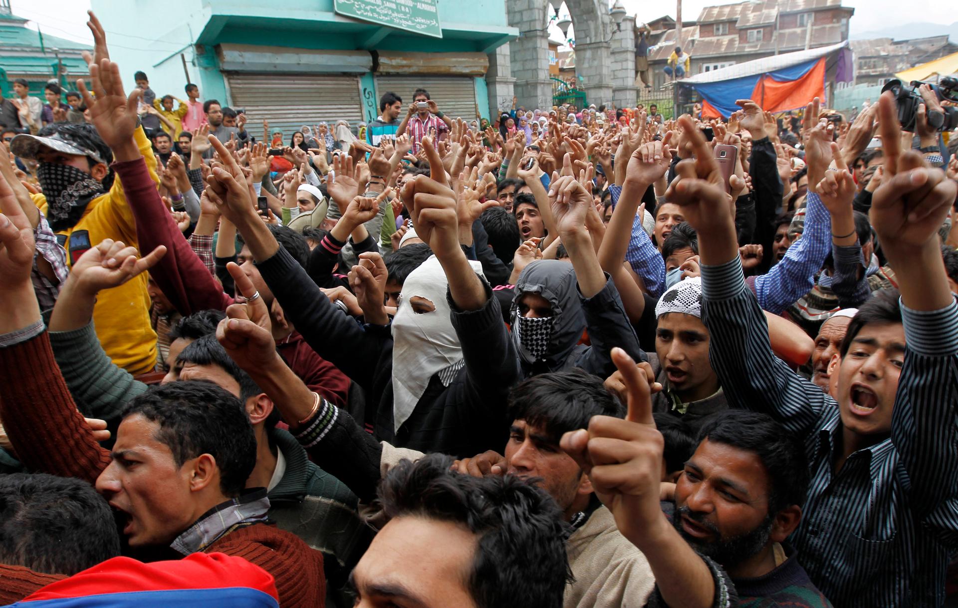 Kashmiri men shout slogans praising Osama Bin Laden after funeral prayers for him in Srinagar May 6, 2011.