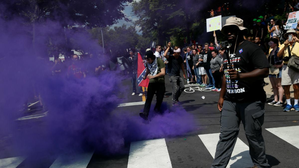 A smoke bomb is thrown at a group of counter-protesters during a clash against members of white nationalist protesters in Charlottesville, Virginia, U.S., August 12, 2017. 