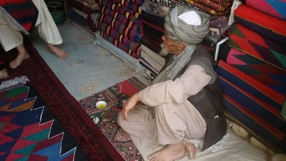 A man selling handwoven rugs in the city of Quetta, in western Pakistan. While the “war rugs” are in demand in Western countries, their value in the local Pakistani market is very low.