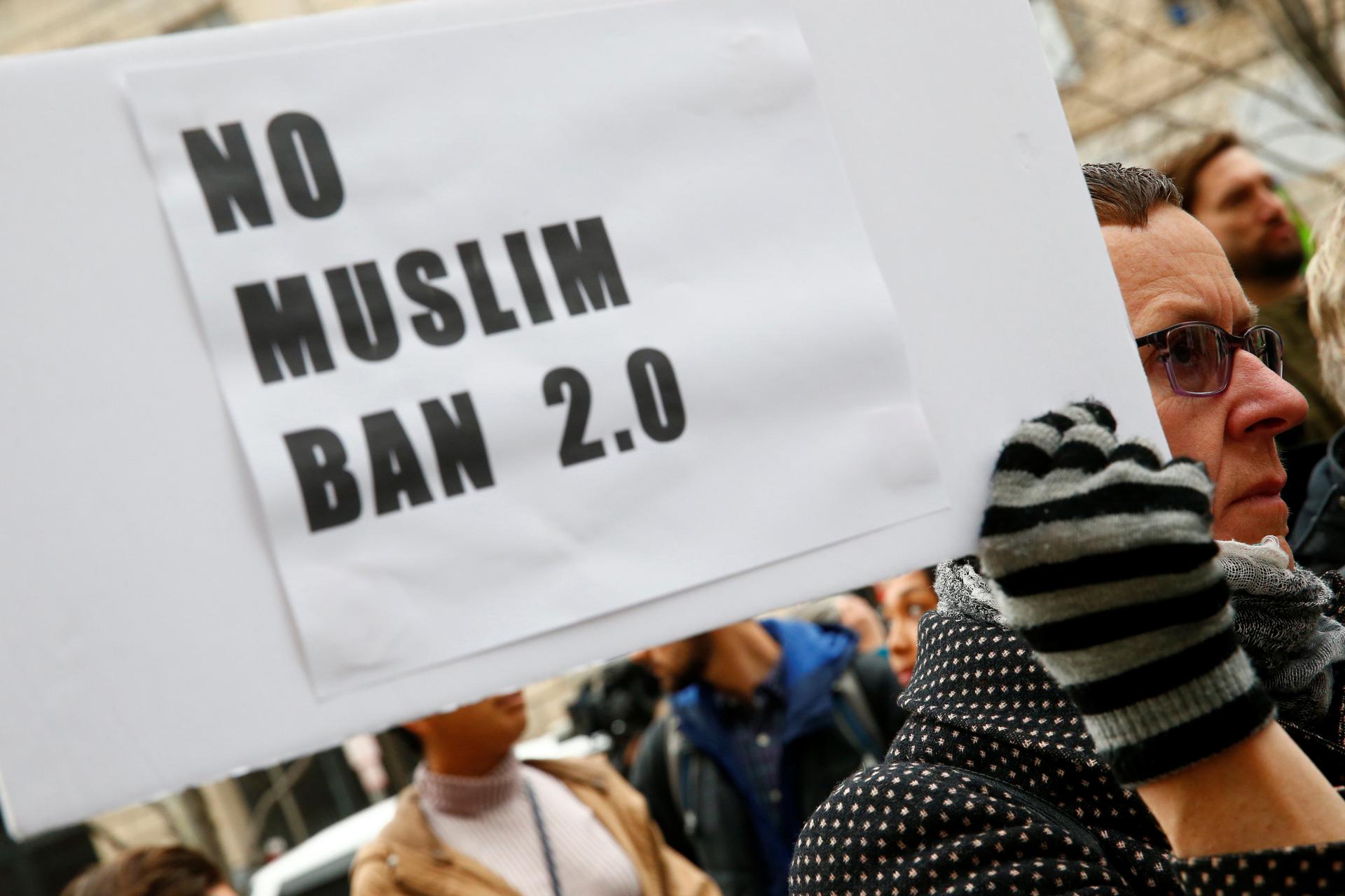 Immigration activists rally against the Trump administration's new ban against travelers from six Muslim-majority nations