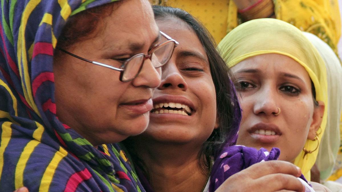 Relatives of Mohammad Akhlaq mourn after he was killed by a mob over rumors that he butchered a cow.