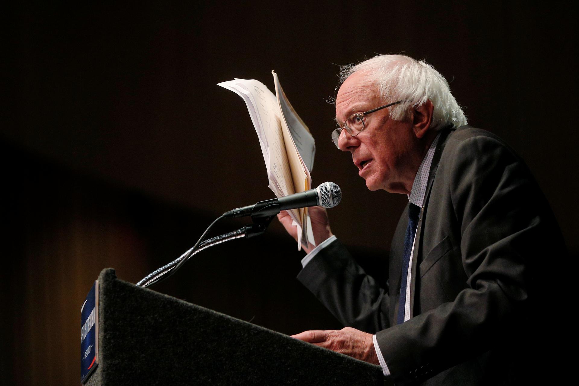 Bernie Sanders holds up his notes
