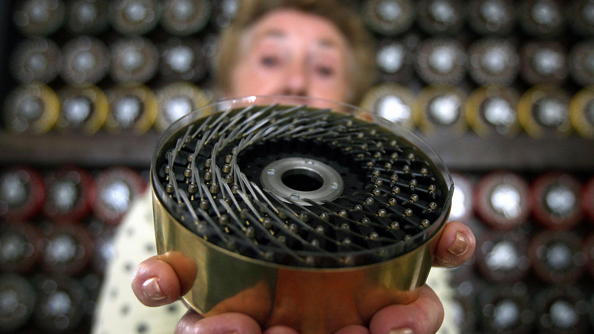 Former Bombe operator Jean Valentine shows a drum of British Turing Bombe machine in Bletchley Park Museum in Bletchley, central England, September 6, 2006. For the first time in sixty years Bletchley Park re-created the way the 'unbreakable' Enigma code 