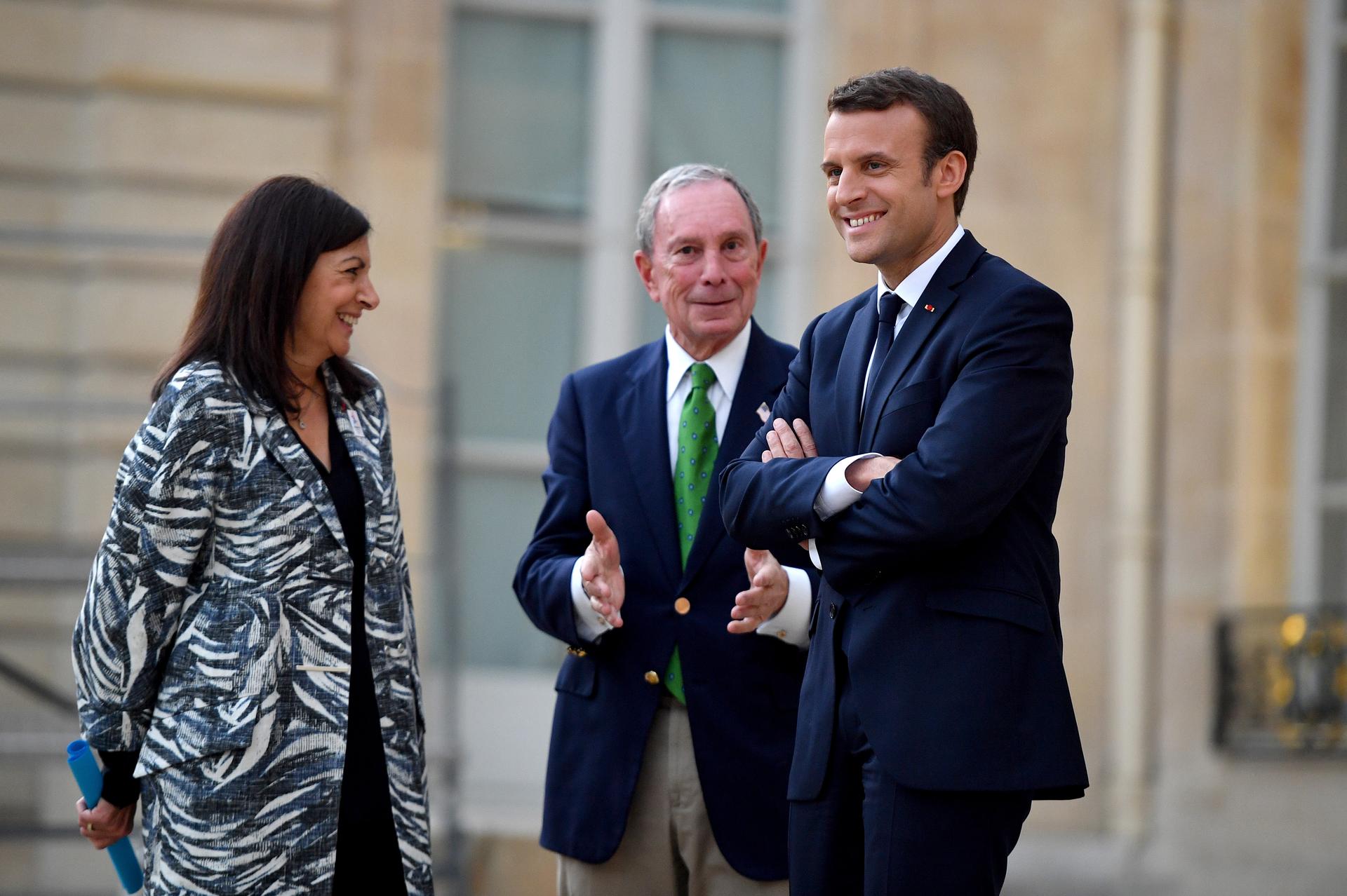 French President Emmanuel Macron, right, Paris Mayor Anne Hidalgo and former mayor of New York City Michael Bloomberg