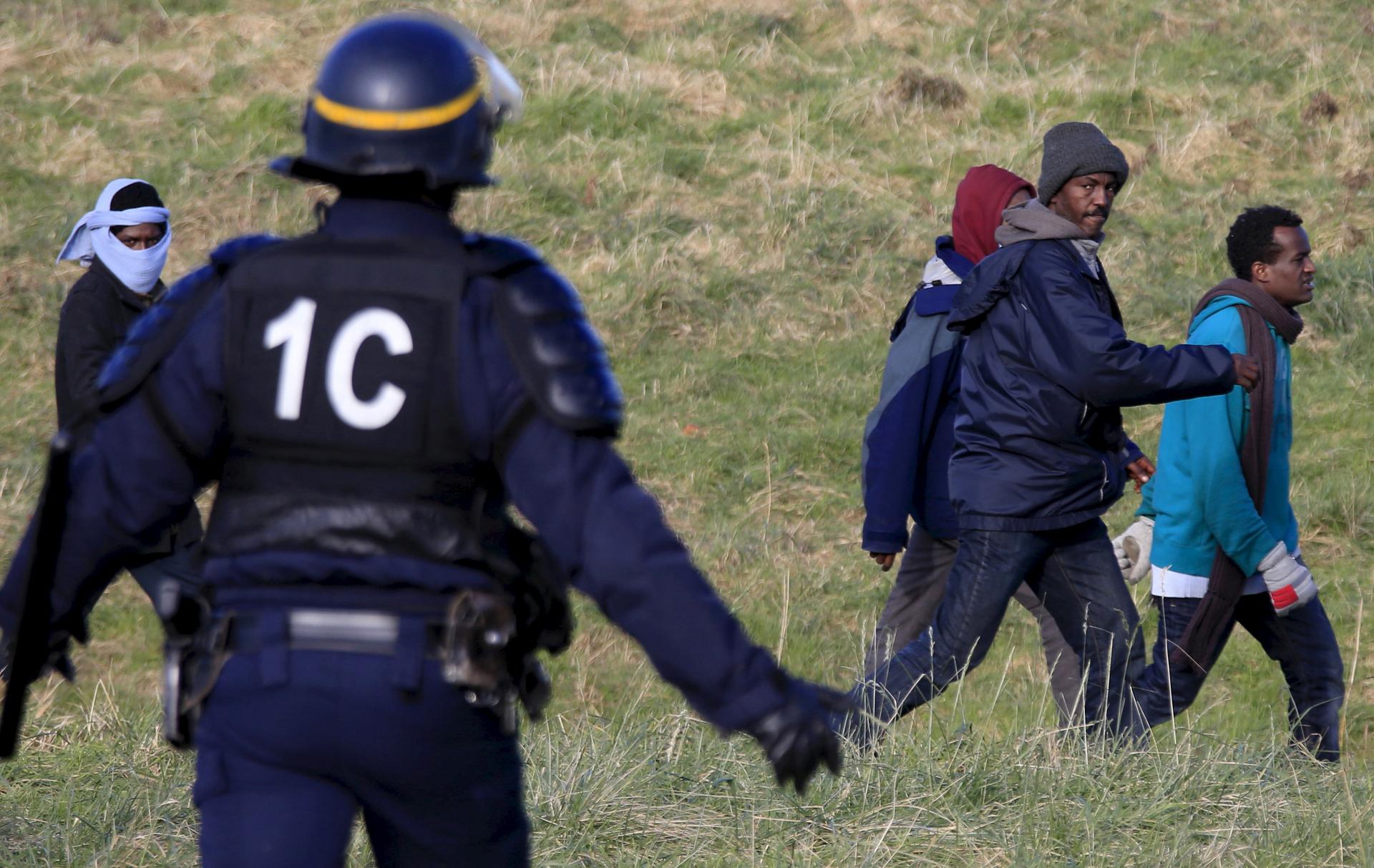 Migrants and police in Calais