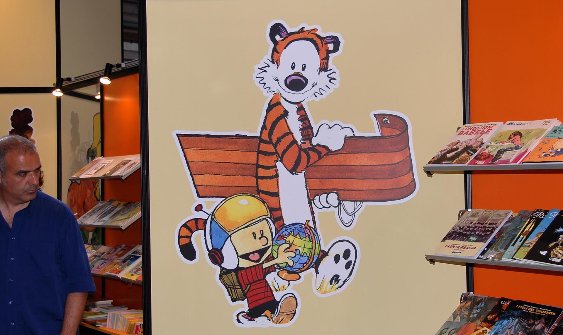 A painting of Calvin and Hobbes graces the wall of a comic book shop.