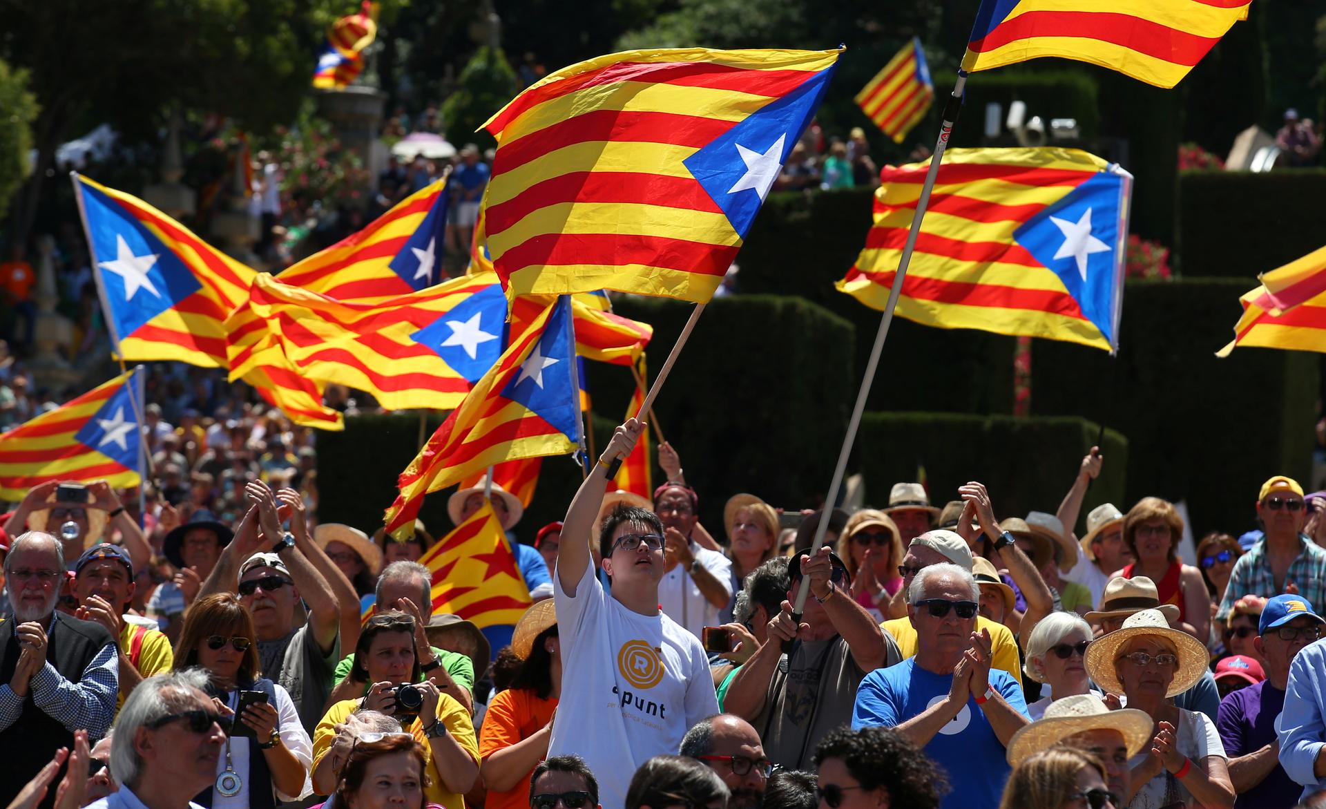People fly "Estelada" flags (the Catalan separatist flag) during a pro-independence rally in Barcelona, Spain June 11, 2017.