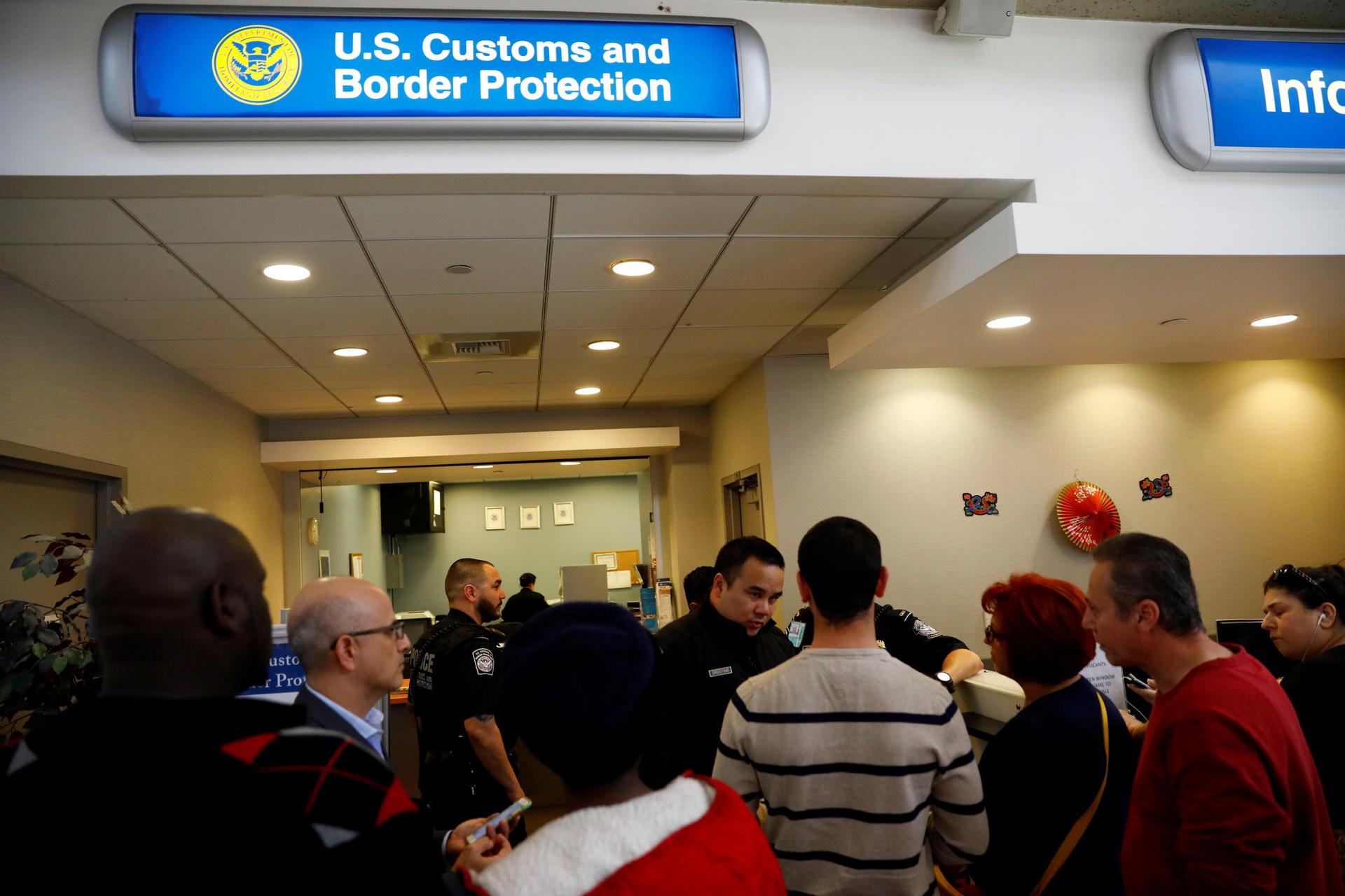 US Customs and Border Protection officers stand outside an office