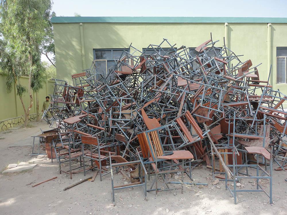 Chairs at a school built, but never occupied, were stripped for firewood.