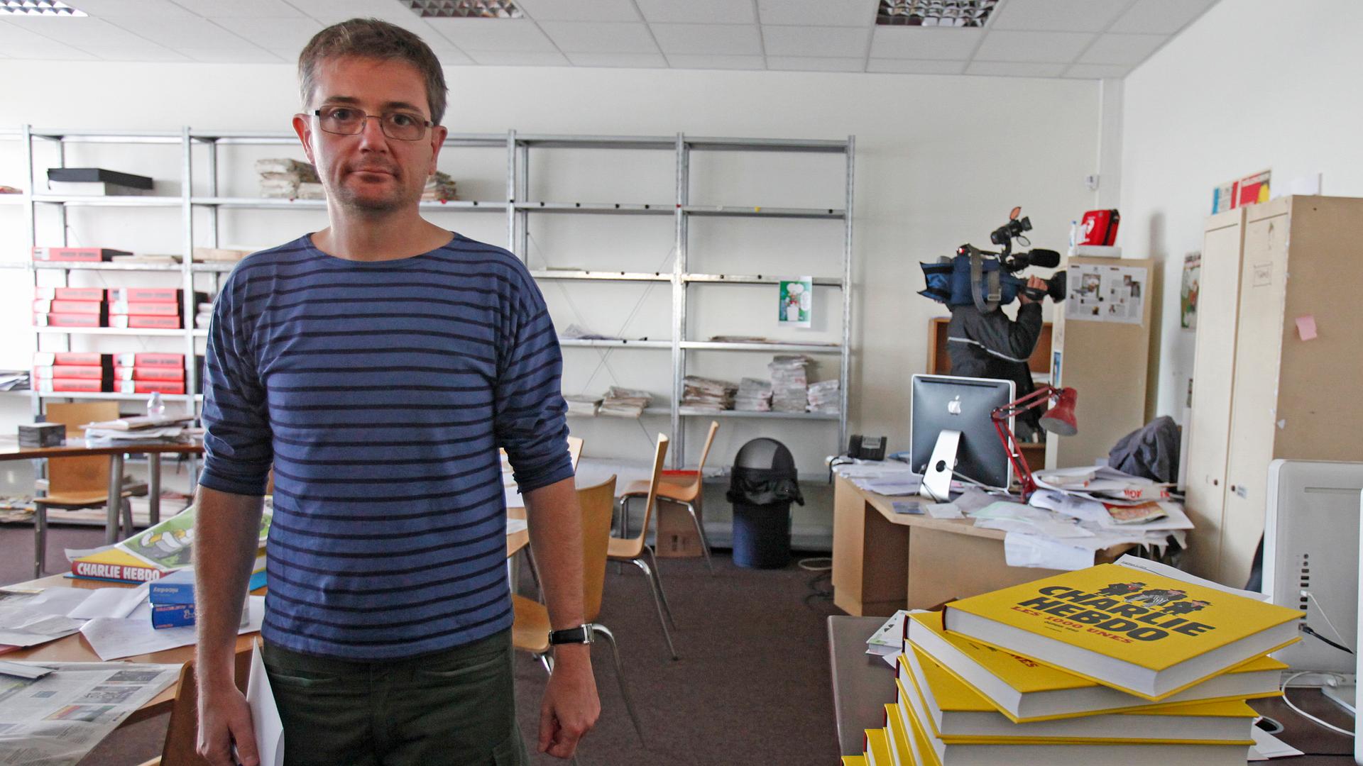 French cartoonist Charb, publishing director of French satirical weekly Charlie Hebdo, poses for photographs at their offices in Paris, September 19, 2012. Charlie Hebdo published cartoons of the Prophet Mohammad on Wednesday, a decision criticised by the