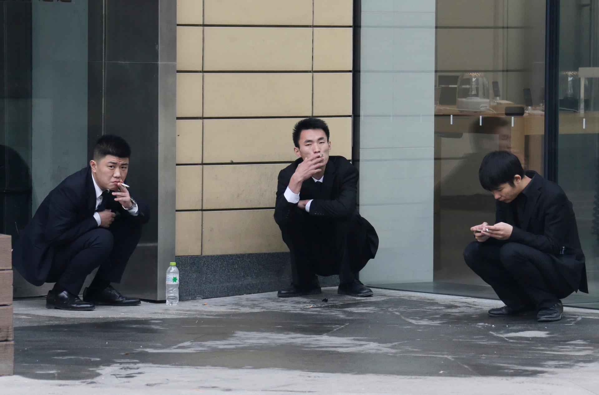 Chinese office workers take a smoke break