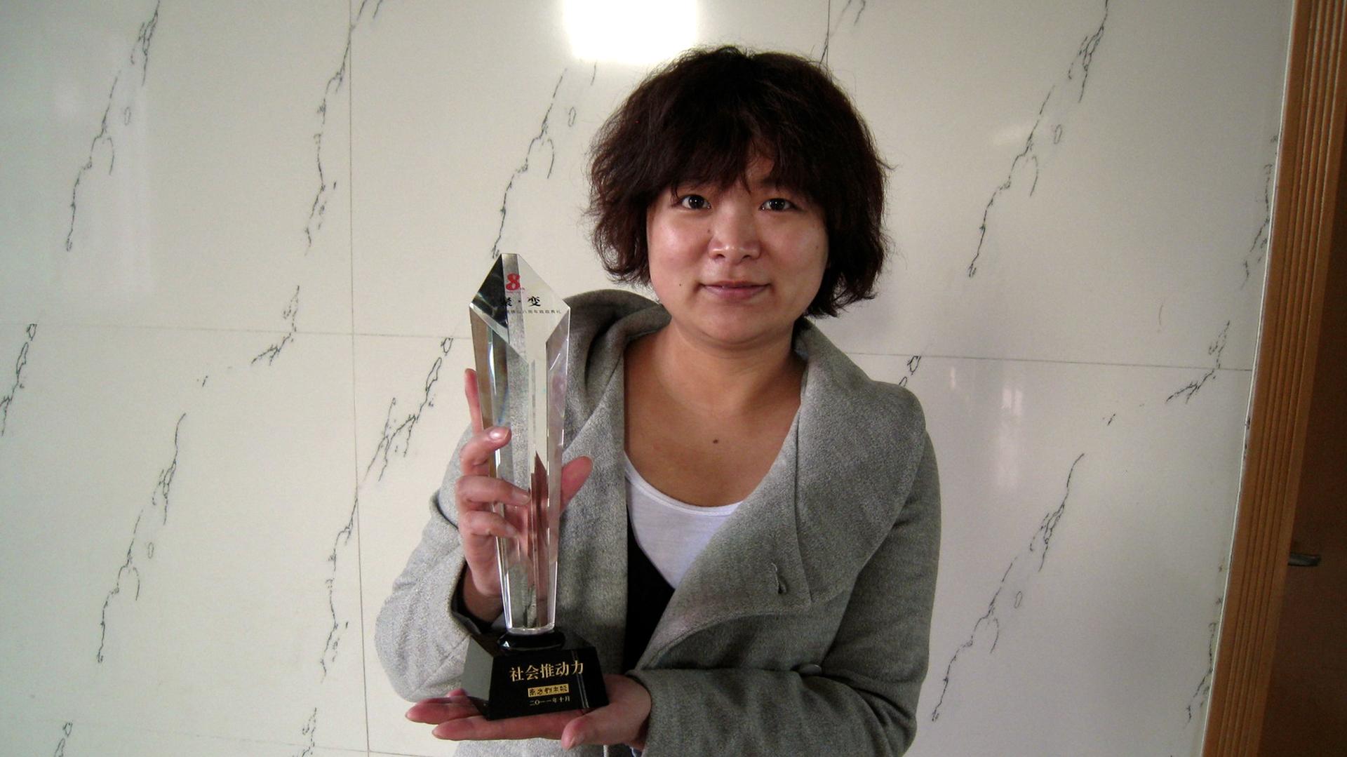 Women’s rights activist Wu Rongrong poses with a trophy in this undated picture taken in an unknown location in China, provided by a women's rights group on April 8, 2015.