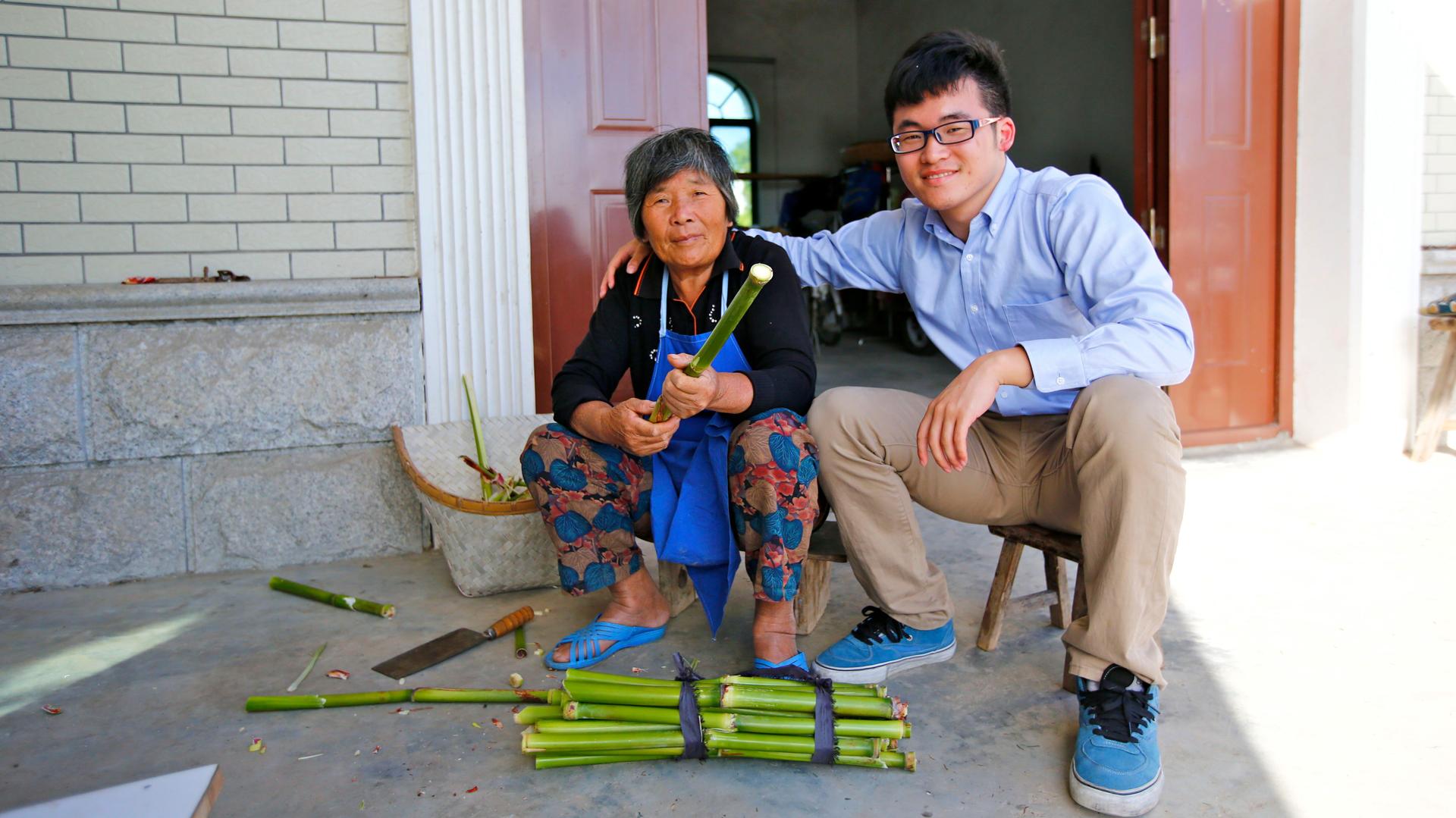 Gu Hangyu, sits with his grandmother Wang Yufang, at her home on Chongming Island near Shanghai. She speaks the Chongming dialect, but not standard Chinese.