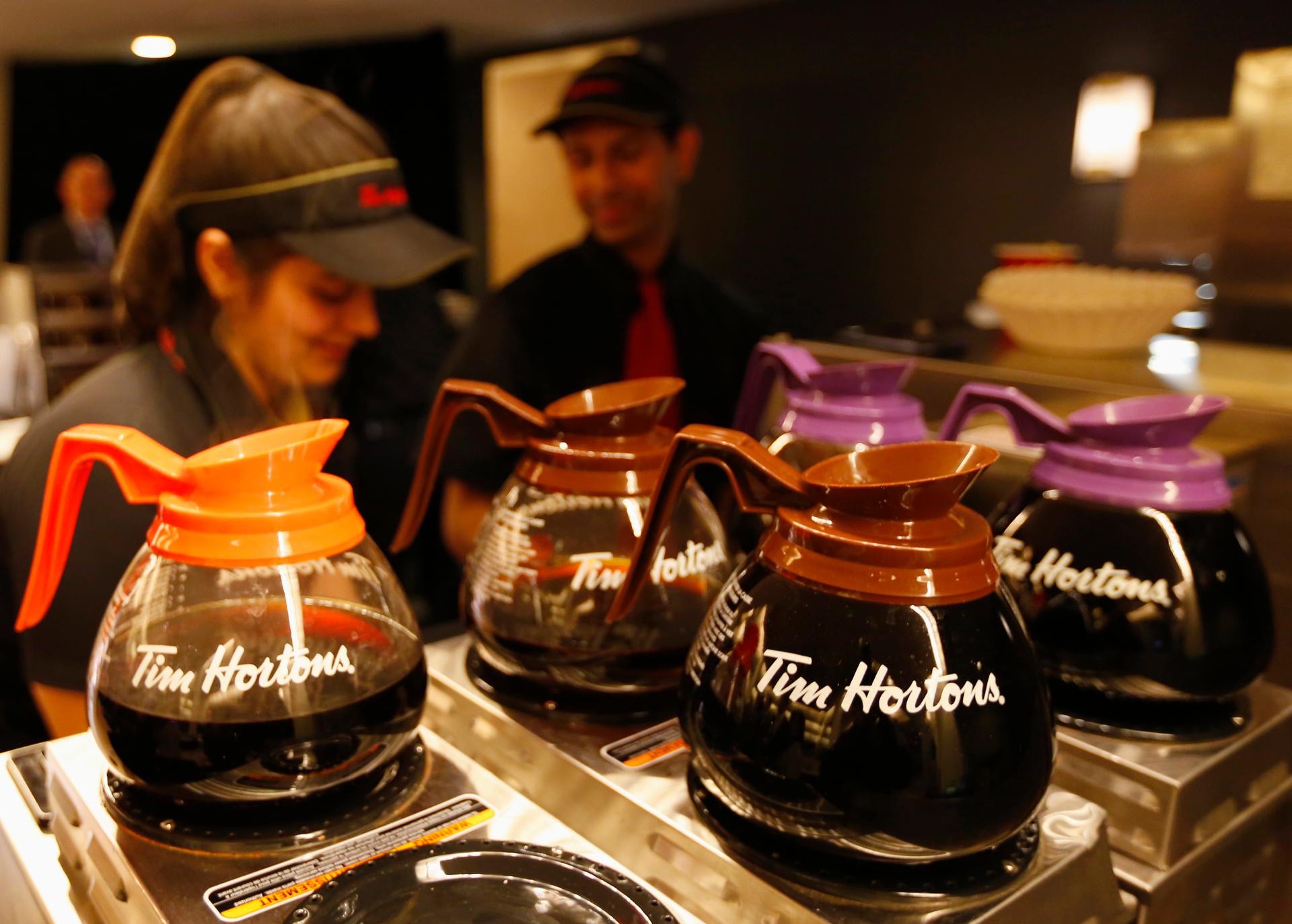 Tim Hortons employees prepare coffee before the company's annual general meeting in Toronto on May 8, 2014.