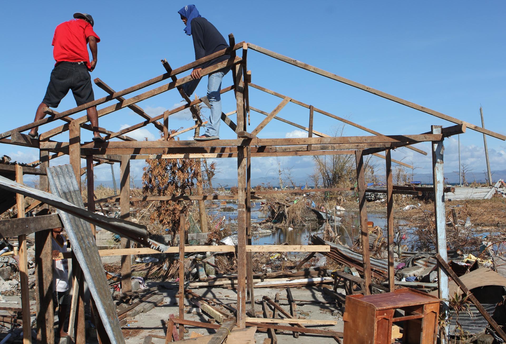 The Vergara family is rebuilding a home on the site of the one devastated by Typhoon Haiyan, using lumber and corrugated tin gathered from the wreckage. 