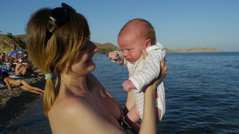 Natalia Antonova at the beach in Crimea with her child, 2011.