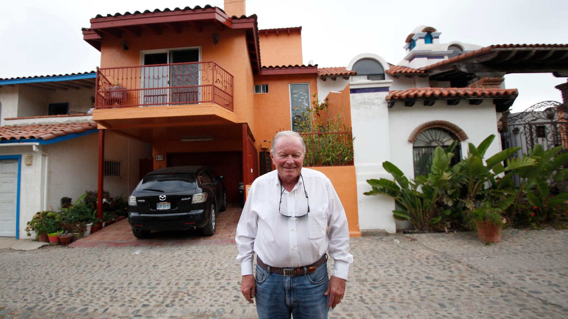 Gil Devine in front of his home in Mexico, near the border.  Devine commutes to work six days a week in San Diego.  
