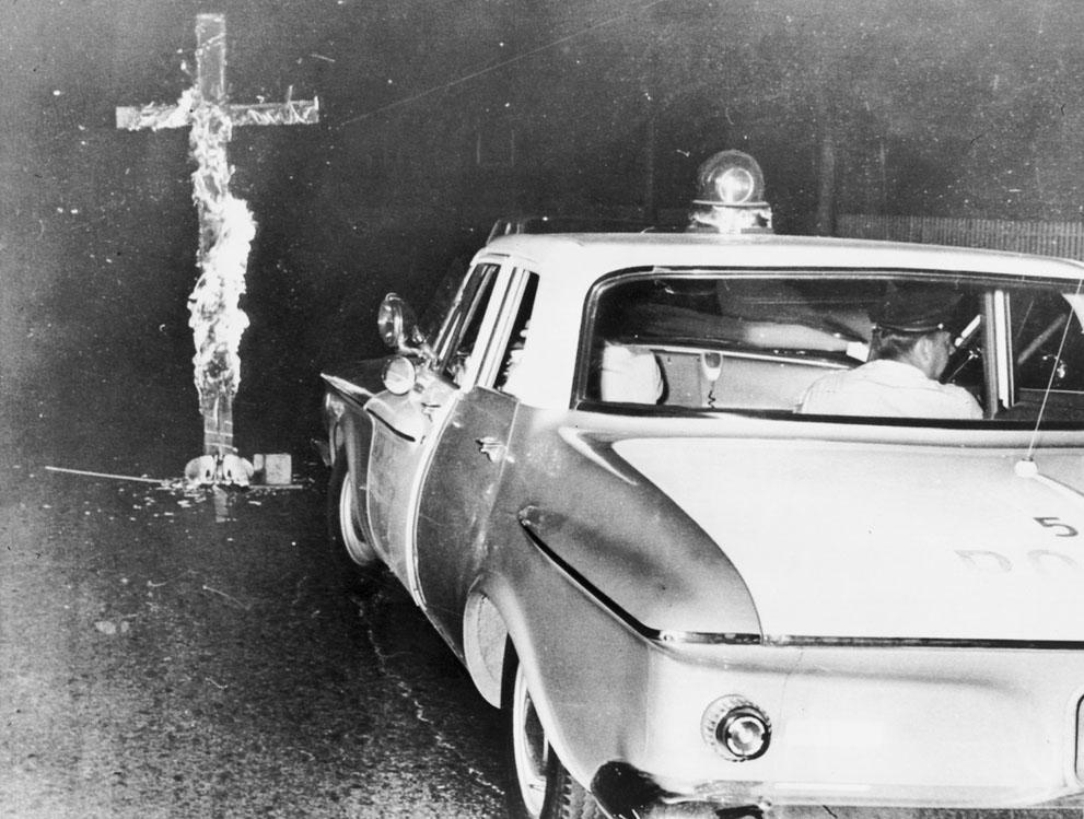 Chicago police move in to knock down a burning cross in front of a home, after an African-American family moved into a previously all white neighborhood, August 3, 1963. The civil rights movement in America was one of the historic trends transforming the 