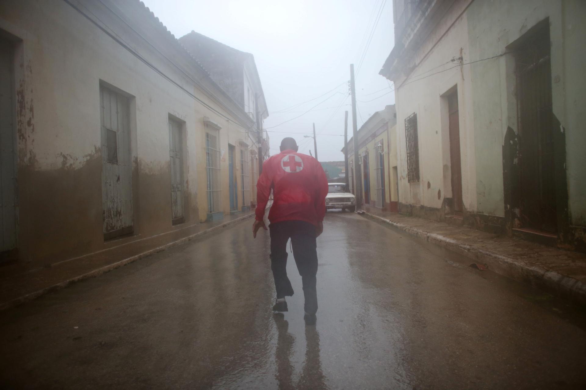 A member of the civil defense runs on the street