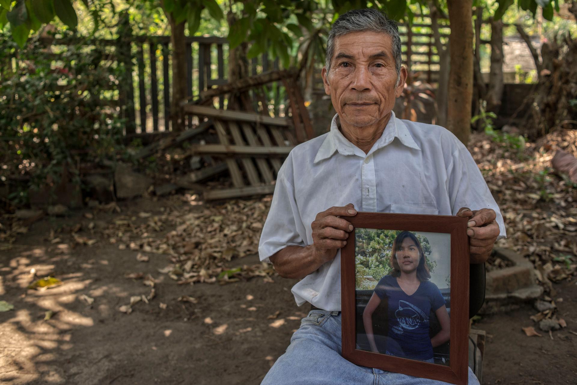 Rene Colocho with an image of his daughter, Angela, who committed suicide after struggling with severe lead poisoning for years. Colocho blames her sickness on pollution from a company which escaped punishment after appealing to the ISDS.