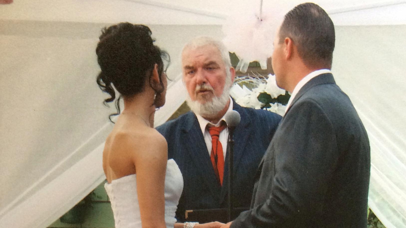 Couple looks at wedding officiant in ceremony