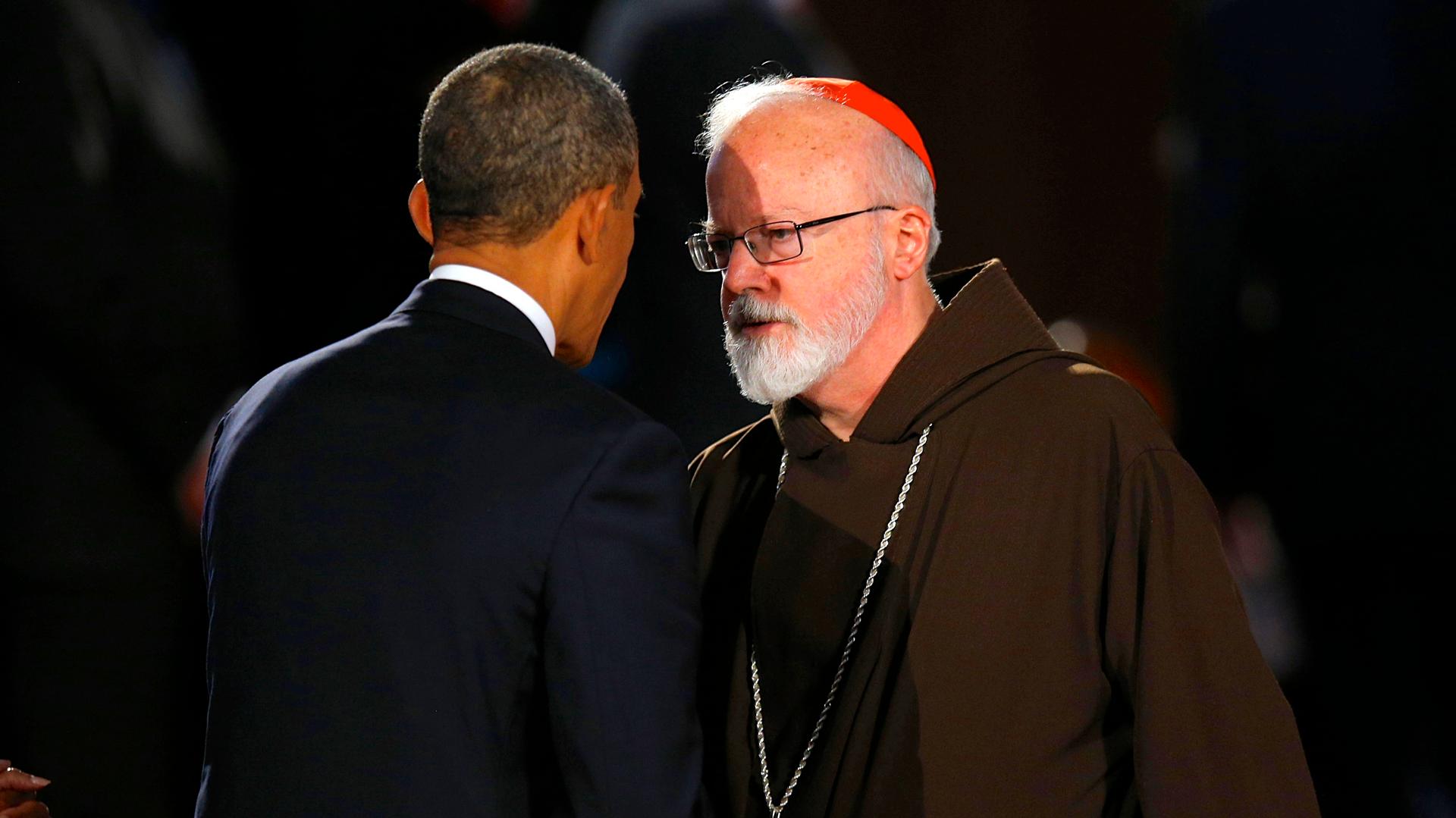President Barack Obama talks to Cardinal Sean O'Malley during an interfaith memorial service for Boston Marathon bombing victims at Boston's Cathedral of the Holy Cross on April 18, 2013.