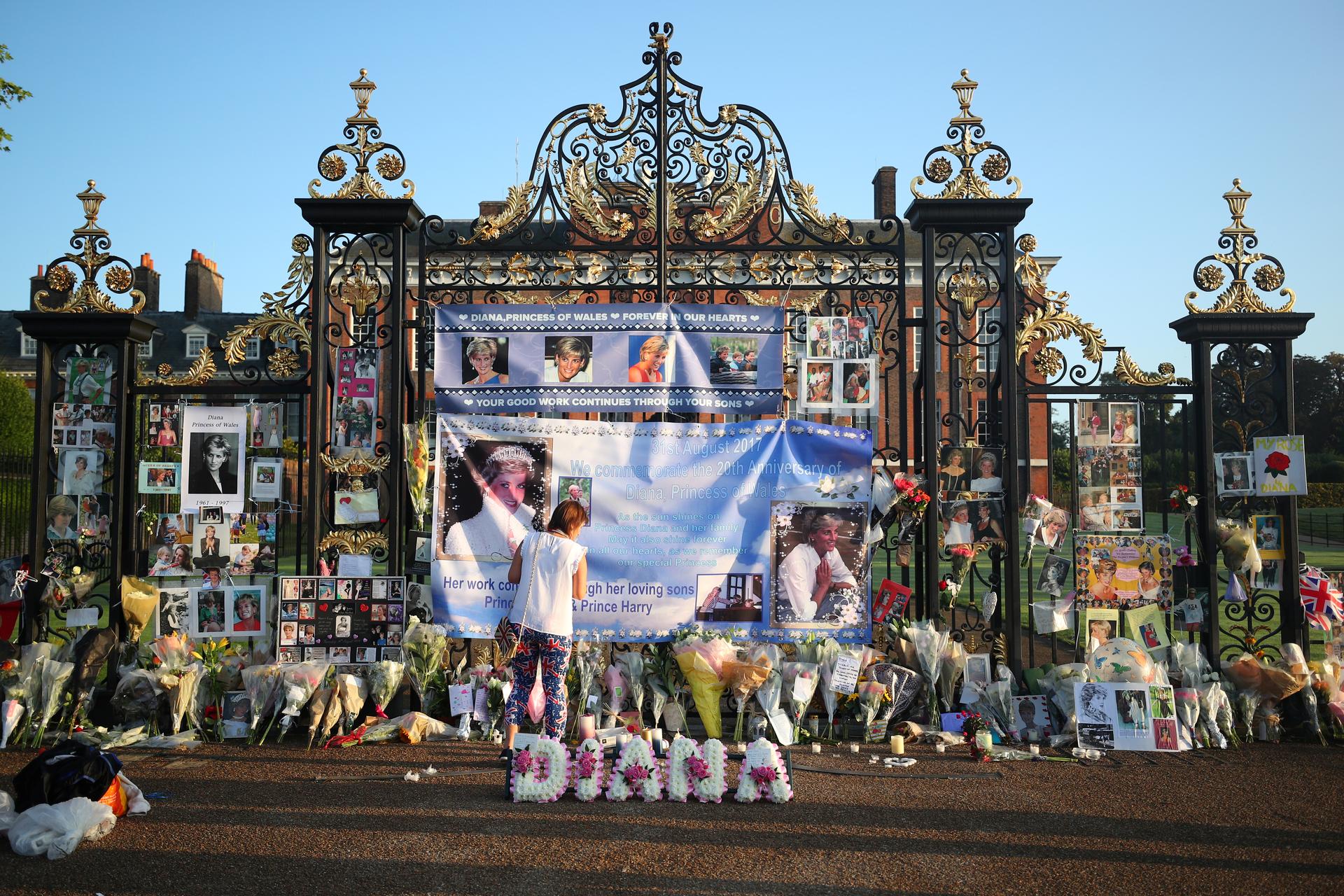 A royal fan looks at flowers and tributes left in memory of the late Princess Diana