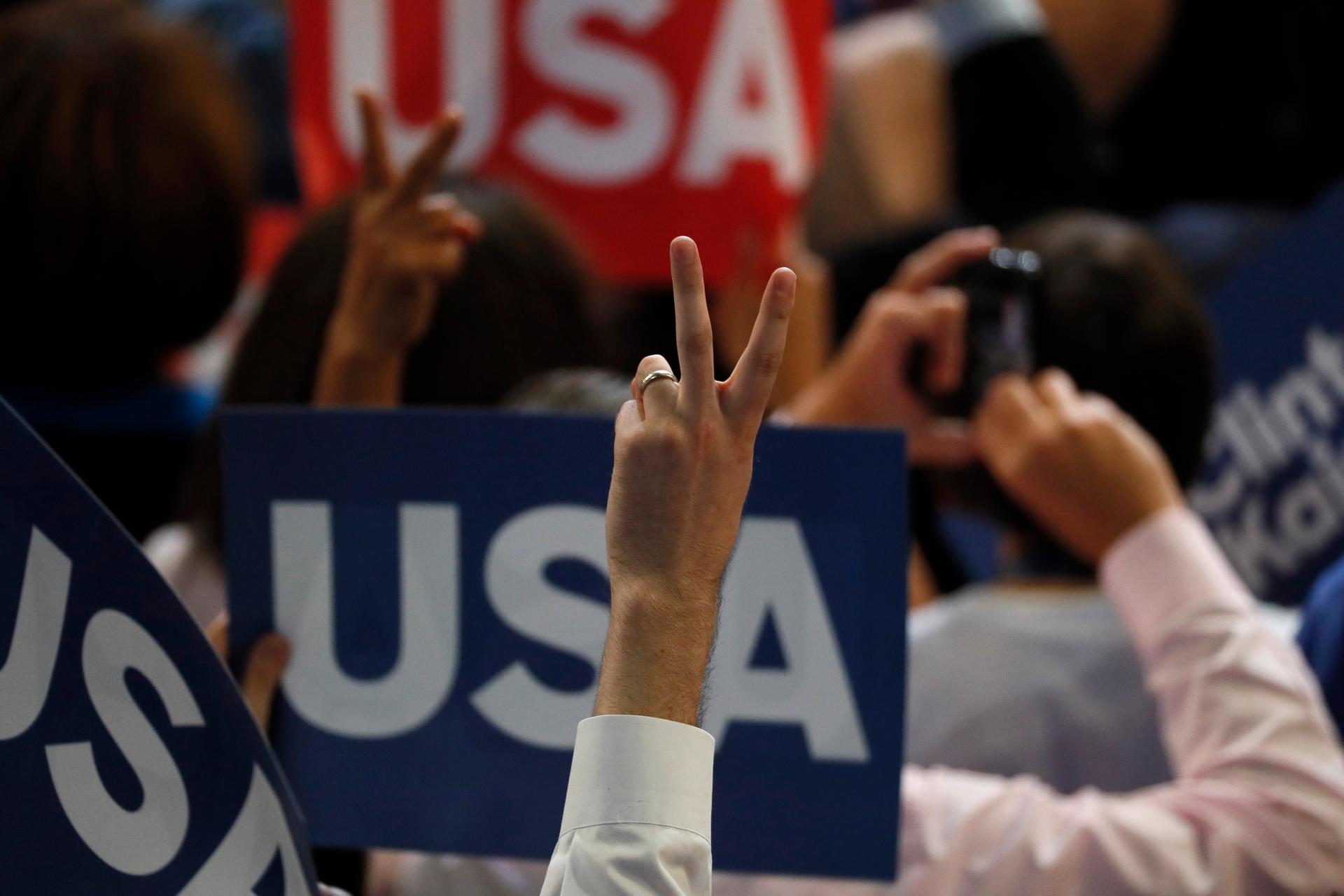 A delegate makes a victory sign.