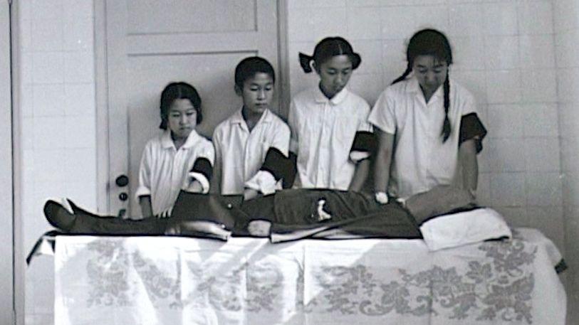 Bian Zhongyun's children mourn the death of their mother, as seen in the documentary "Though I am Gone." Bian was a school principal who beaten to death 1968 by a crowd. 