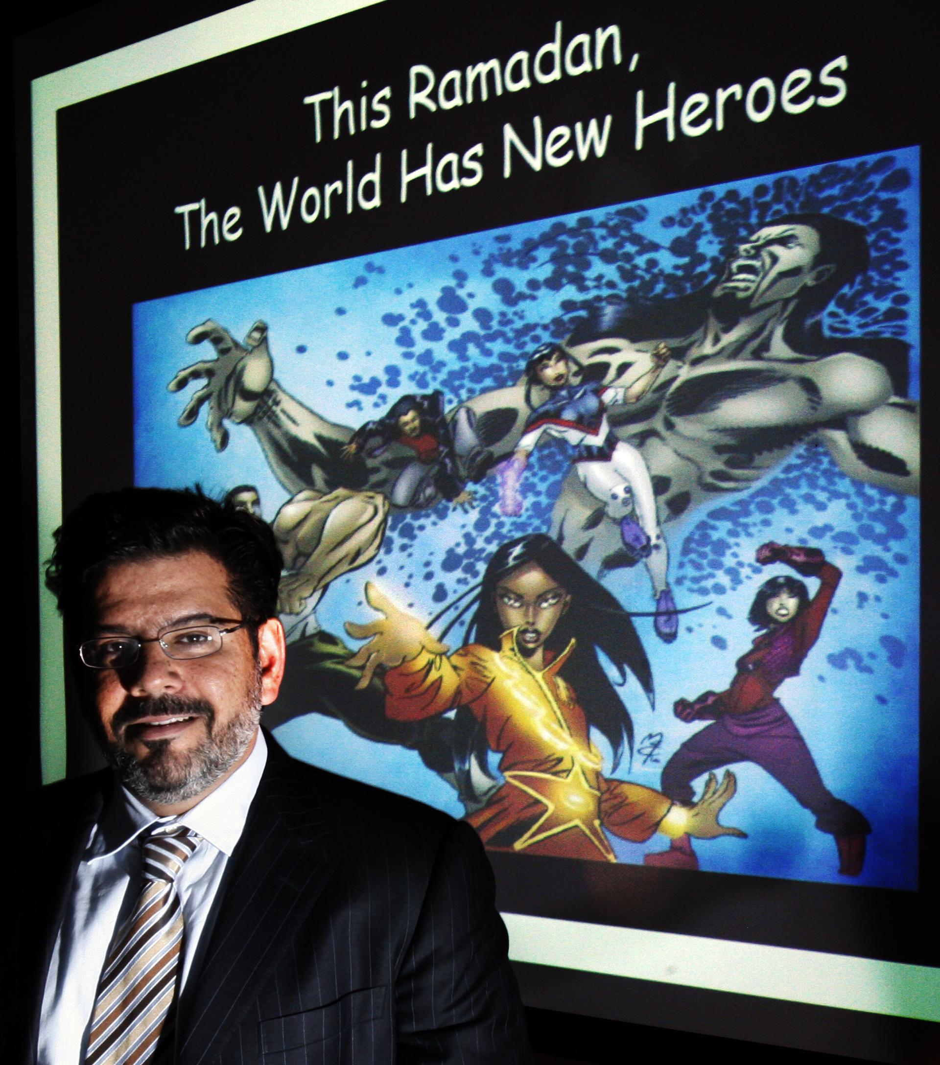Kuwaiti psychologist Naif Al-Mutawa poses in front of cartoon characters he created for his comic book and television series "The 99'. The comic book series features cartoon superheroes for Muslim readers that incorporate Muslim values but now Saudi relig