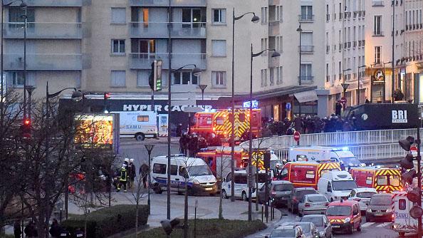 French firemen and emergency doctors enter a kosher deli during a hostage situation at Port de Vincennes on January 9, 2015 in Paris, France.
